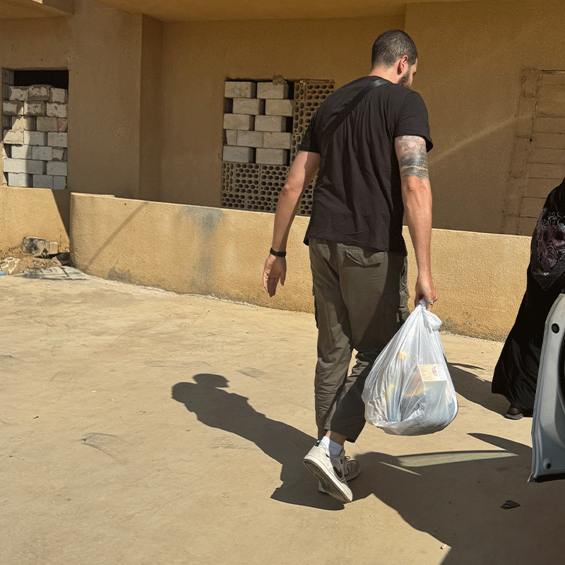 image of Ahmed distributing charity